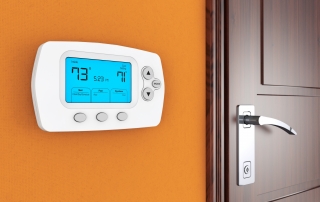 Modern Programming Thermostat on a wall near door