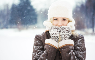 woman in winter wearing warm clothing to stay warm