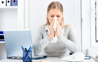 Woman Sneezing Because of Allergies Due to Inefficient HVAC System