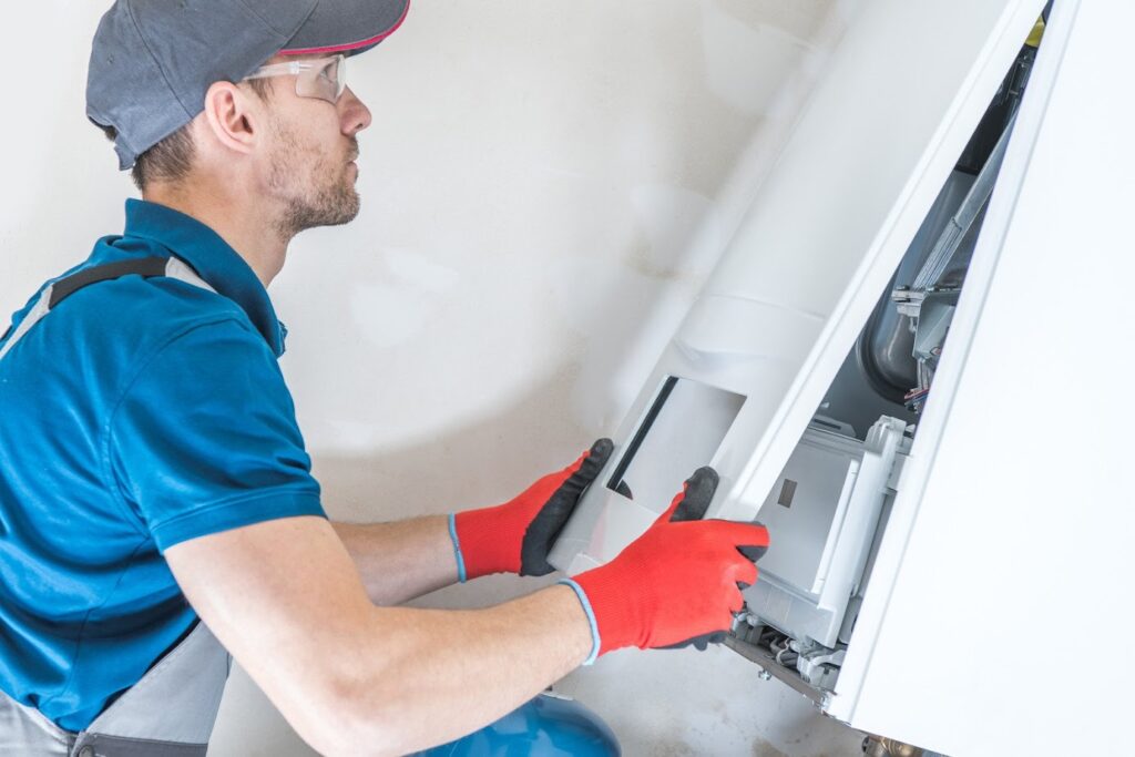 hvac contractor replacing old furnace to help reduce energy bills by installing a new furnace